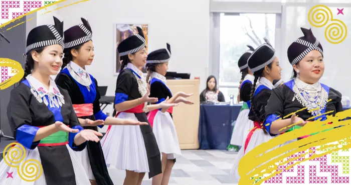 Hmong children dancing in traditional clothing performing