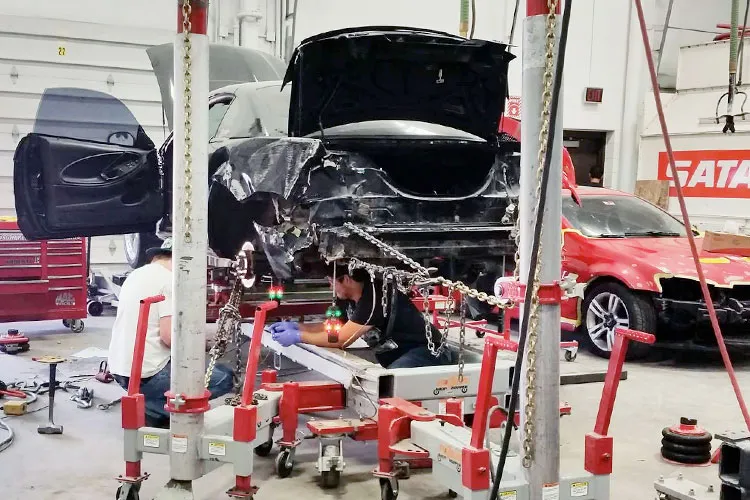 auto collision repair students working on correcting structural damage