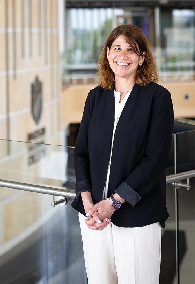 Dr. Berne smiling and standing