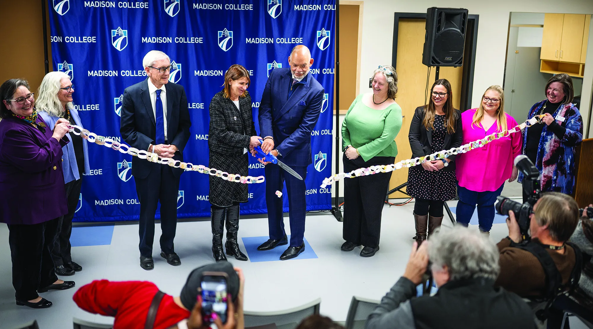 Madison College President Dr. Berne cuts ribbon during ELC ceremony, surrounded by Gov. Tony Evers and City of Madison Mayor and other Madison College officials.