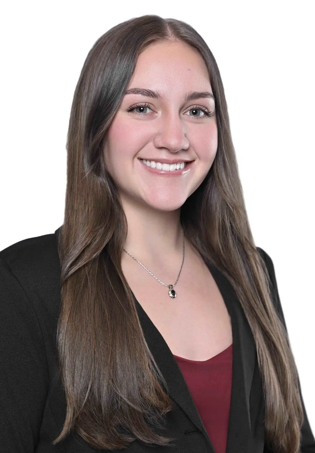 Student with long brown hair, wearing a black blazer and red shirt.