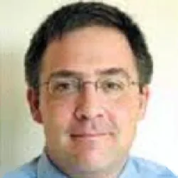 Photo of Grant Emmel, with short dark hair and glasses.