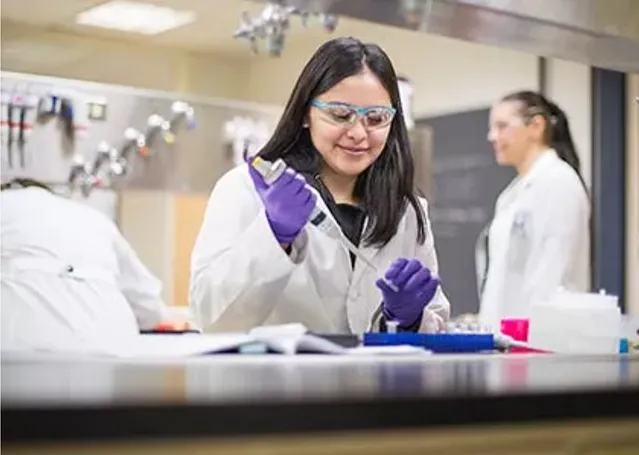 A student works with lab equipment in class.