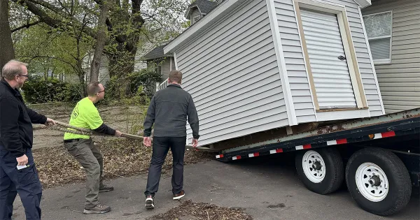 Madison College students and staff, along with DOC staff, help deliver the donated shed to Porchlight Inc. in Madison.