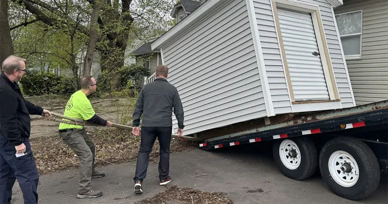 Madison College students and staff, along with DOC staff, help deliver the donated shed to Porchlight Inc. in Madison.