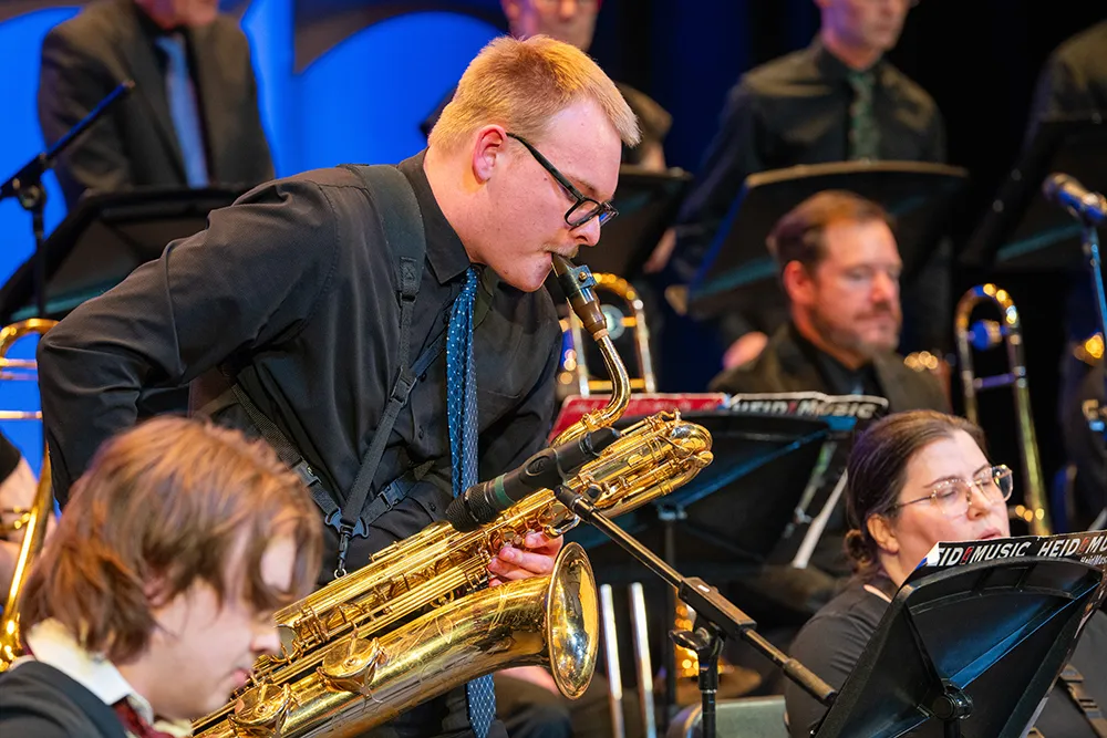 A baritone saxophonist plays a solo during a Madison College Jazz Ensemble concert
