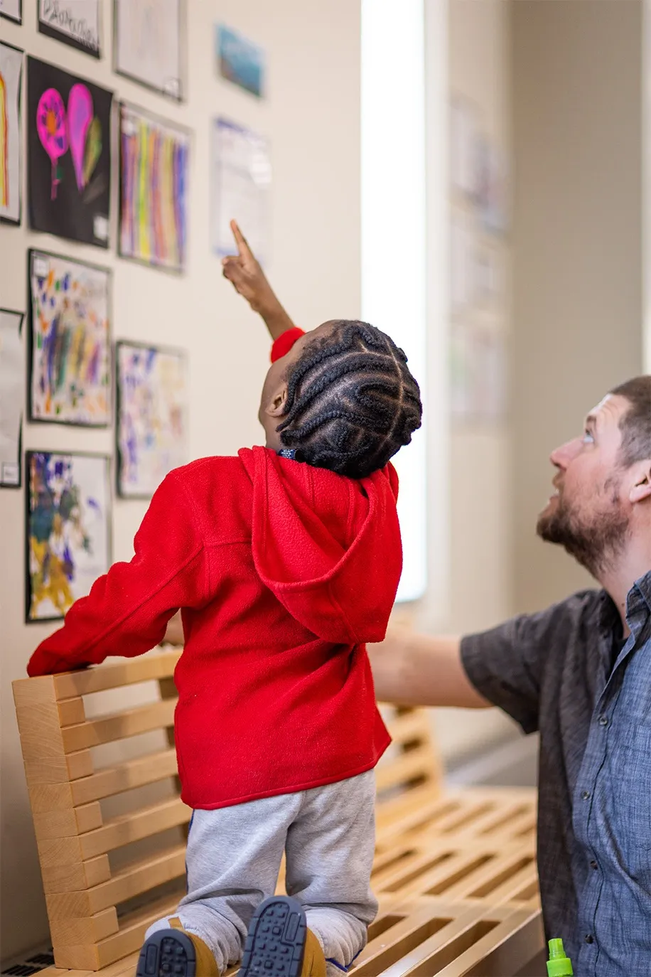 A child admires student art at the ELC.