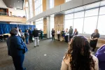 People waiting around a blue curtain from a different angle