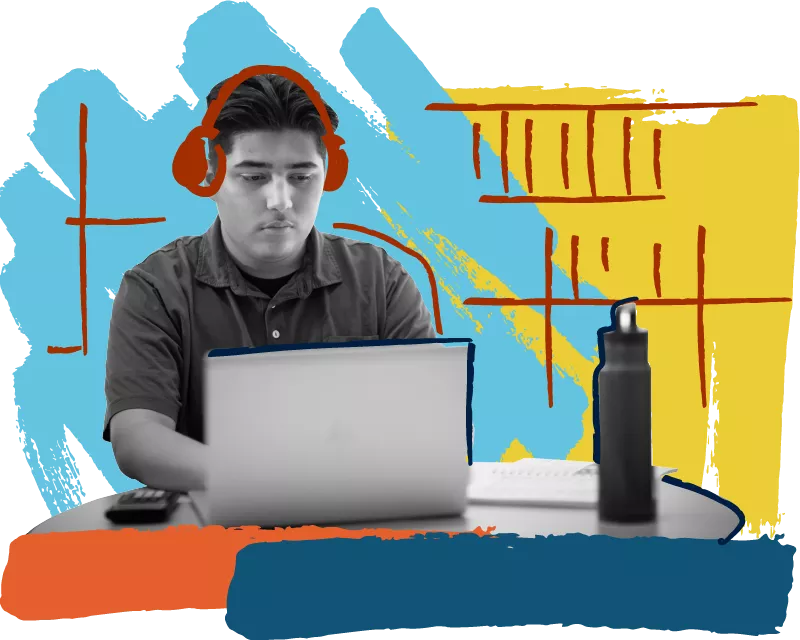 A Madison College student wearing headphones using a laptop.