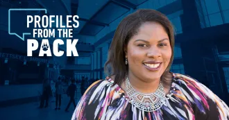 Image of Autumn Maria Reed, wearing blouse with colors of blue, black, red and purple, smiling, with the Profiles from the Pack letter logo in background.