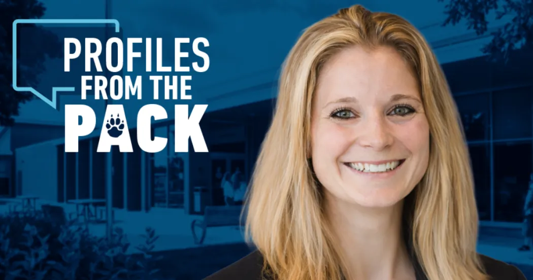 Female (Chelsey Bauer) smiling at camera, blonde hair, dark blazer. Profiles from the Pack logo behind with Watertown entrance and students.