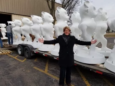 Provost Turina Bakken stands with white Bucky statues. 