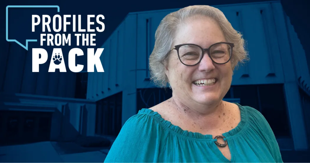 Image of Cathy Hare in a blue shirt smiling. A Profiles from the Pack logo with the exterior of the Commercial Avenue campus building is in the background.