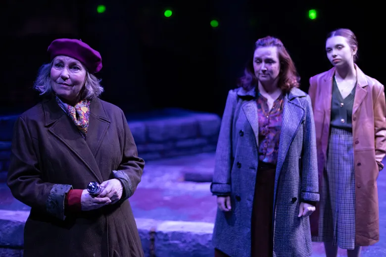 Three women of varying ages in a scene from Women of Lockerbie