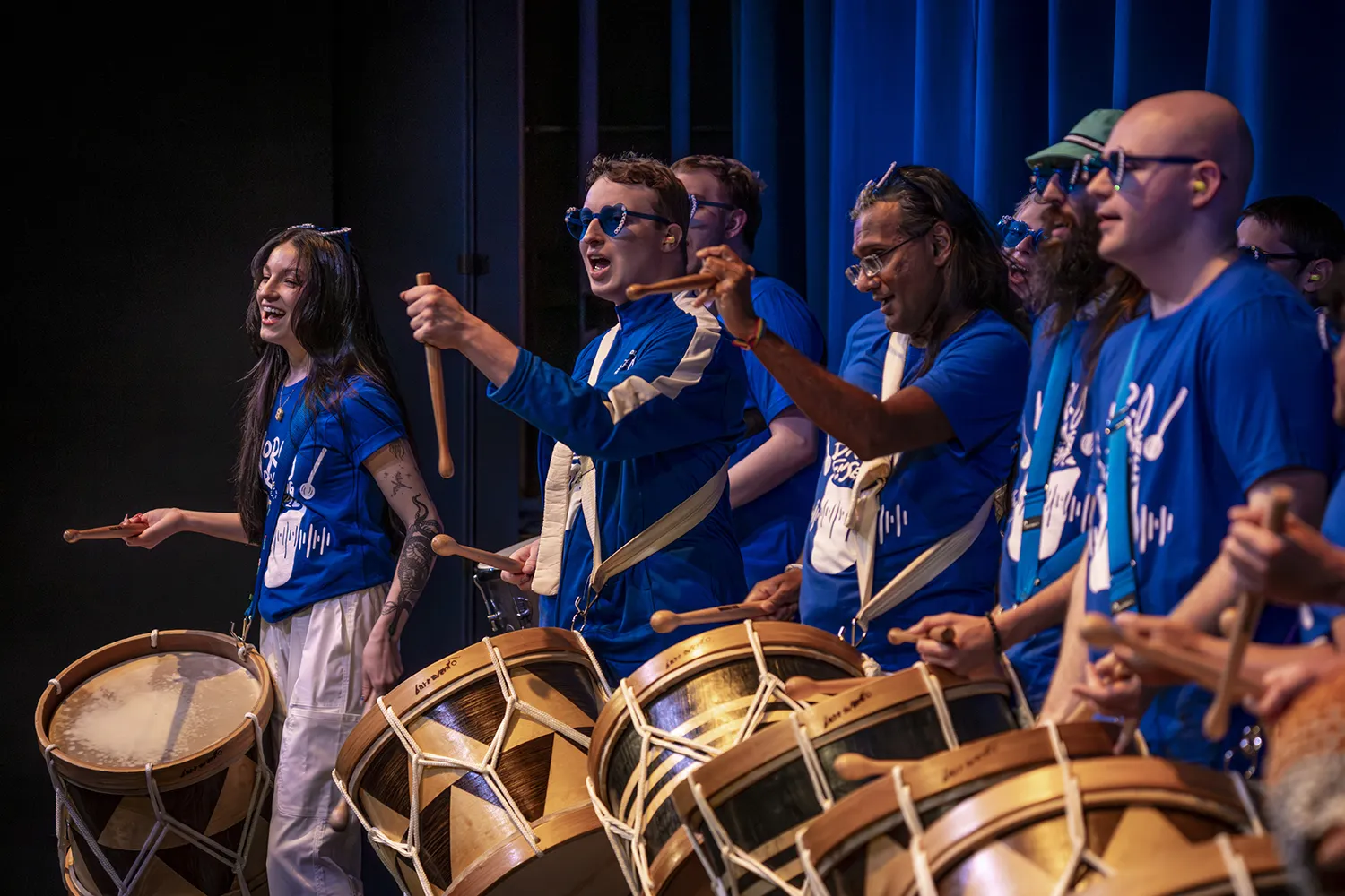 Members of the Madison College World Drumming Ensemble playing Brazilian alfaia drums
